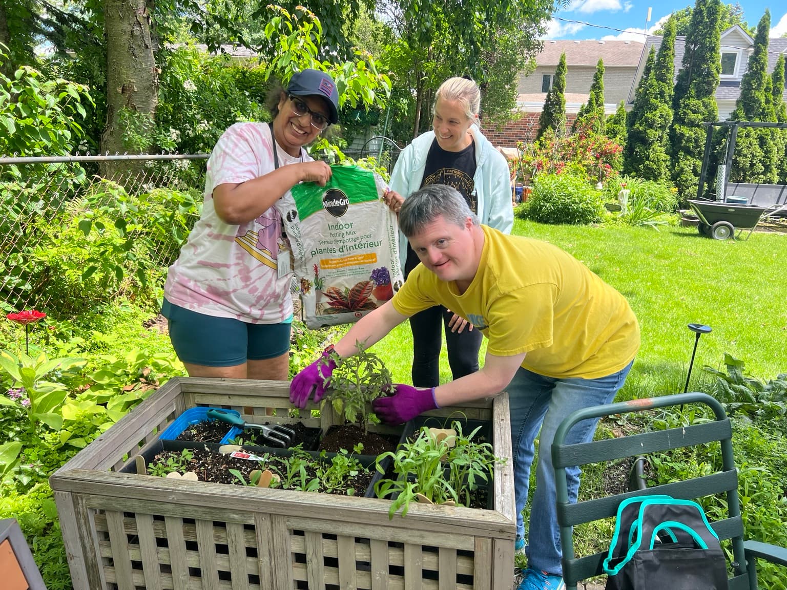 Catching Stars participants gardening together during a hands-on inclusive adult community outing.