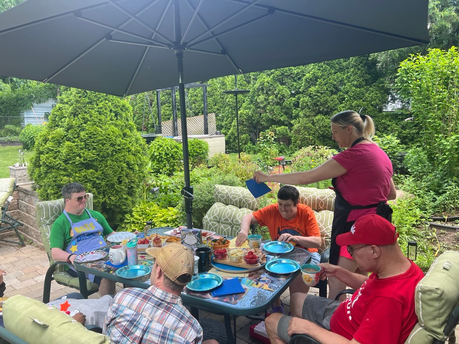 Catching Stars Friends Dinner participants sharing a completed outdoor meal around one table.