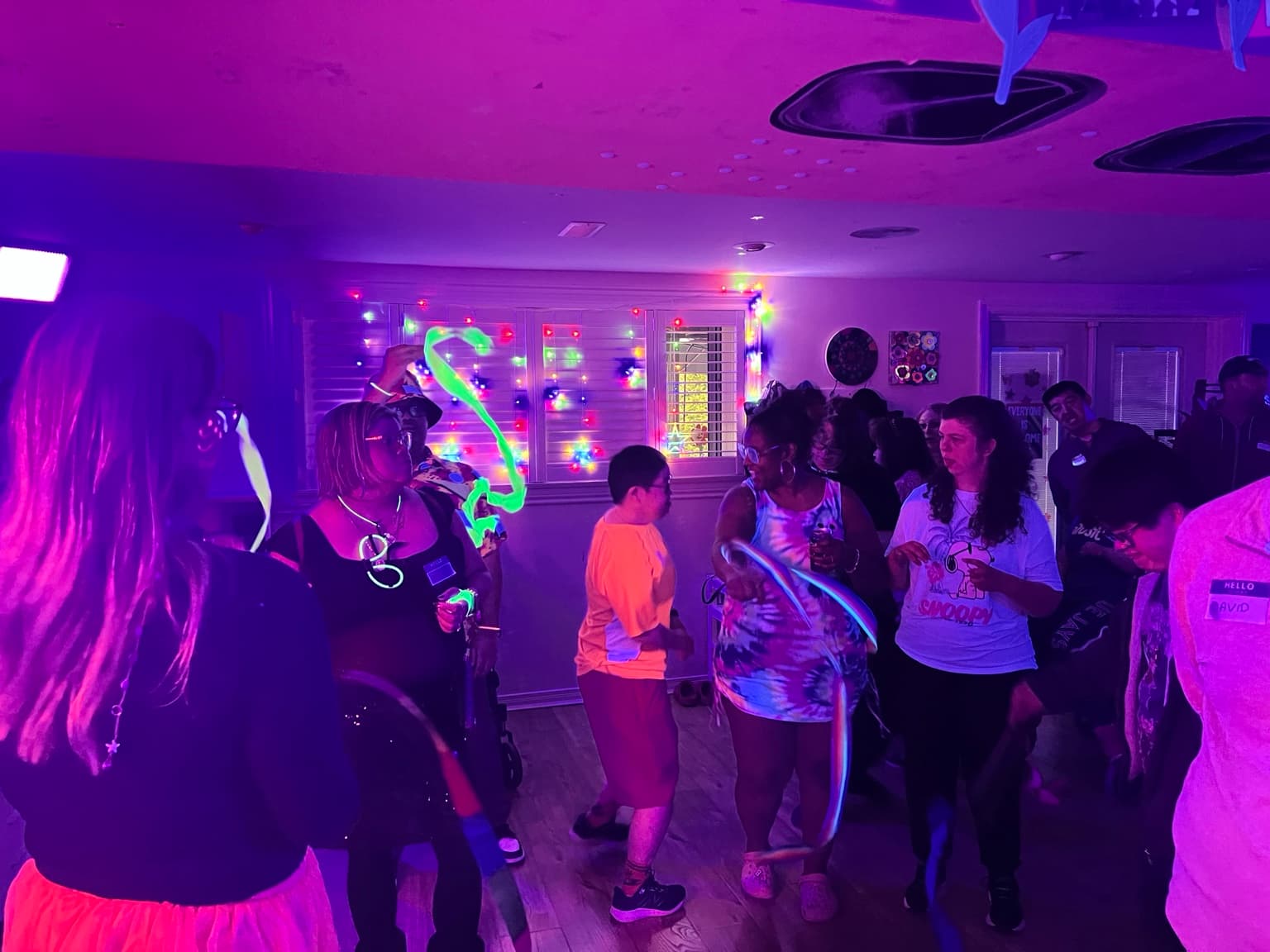 Catching Stars participants gathered at Glow Dance Night with glowing lights and music.