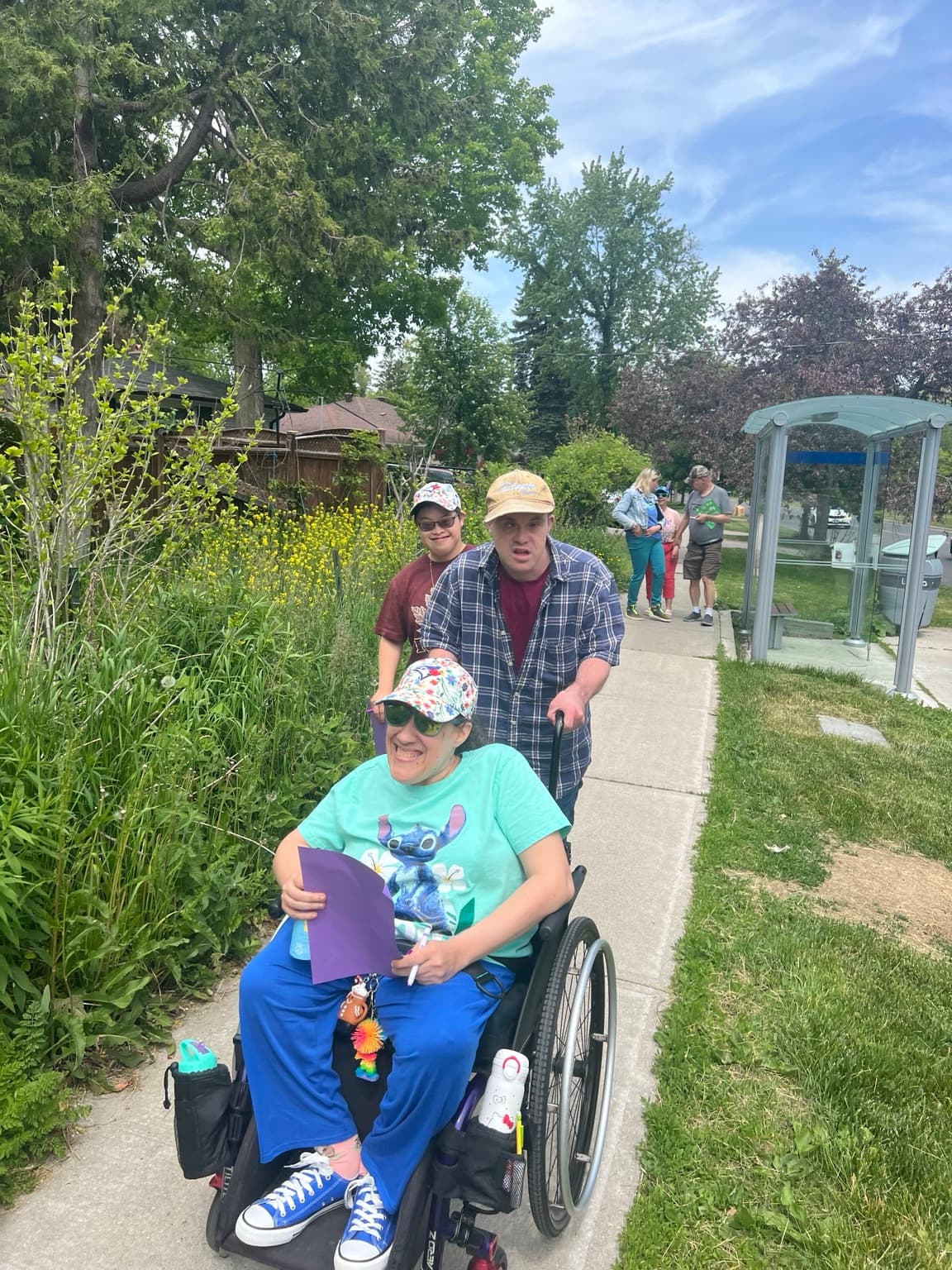 Catching Stars participants and supporters walking together during an accessible group outing.