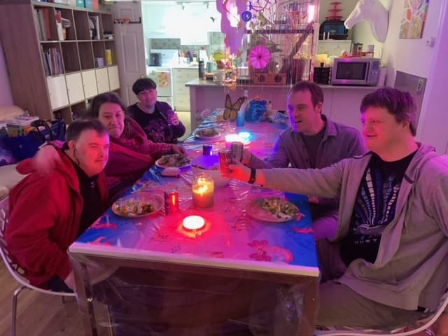 Catching Stars Friends Dinner participants sharing dinner and conversation during an adult social program.